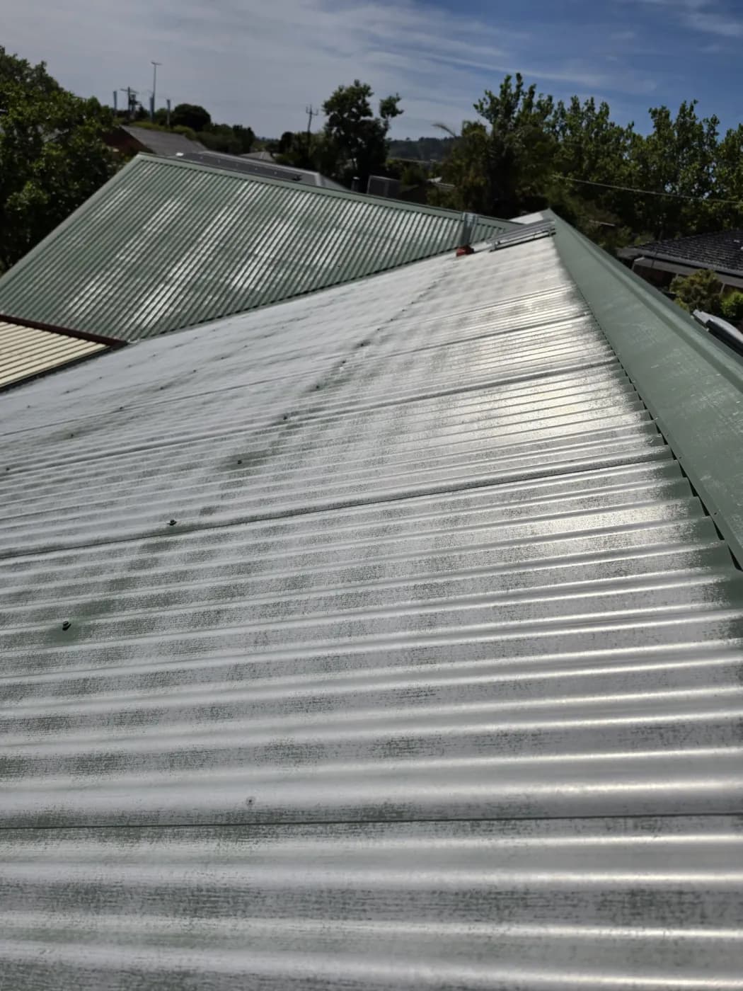 The roof up close before, the old paint worn off and patchy